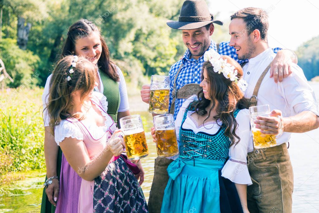 Five friends, men and women, having fun on Bavarian RIver 
