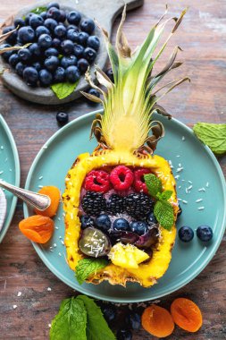 ahşap masada taze olgun ananas ve çilek ile lezzetli tatlı üst görünümü