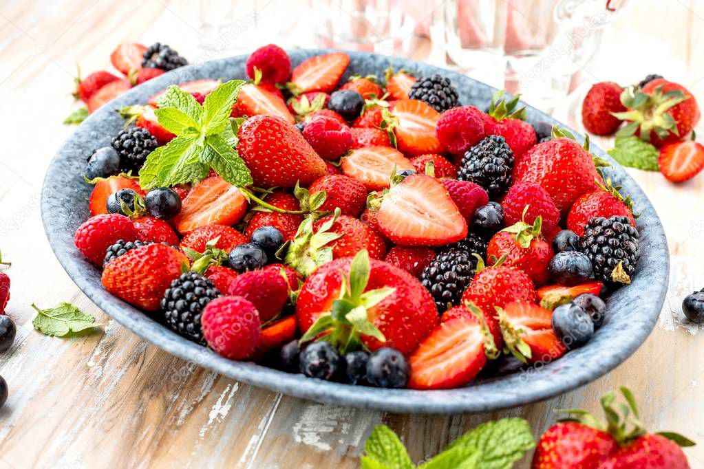 close-up view of fresh ripe berries on wooden surface 