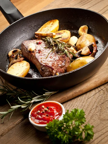 Tasty Grilled Steak Sirloin Potatoes Mushrooms Frying Pan Sauce Wooden — Stock Photo, Image