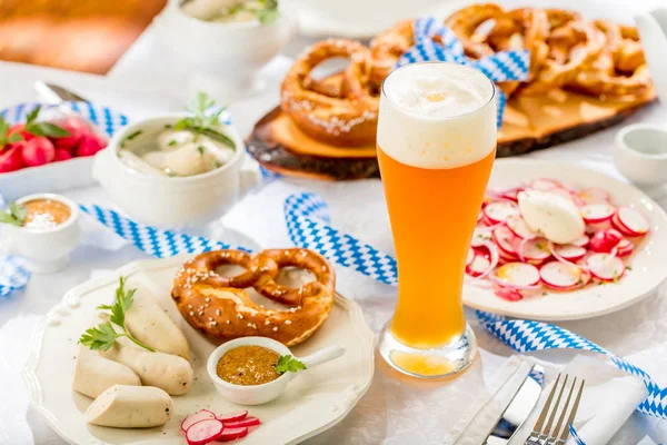 glass of beer and tasty snacks on table, oktoberfest concept