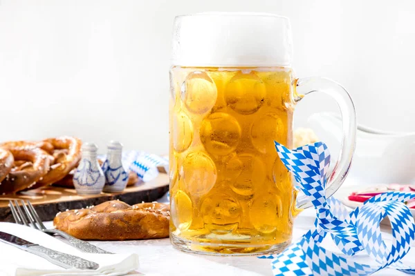 close-up view of glass of beer and pretzels on table, oktoberfest concept