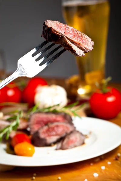 close-up view of fork with delicious grilled venison fillet