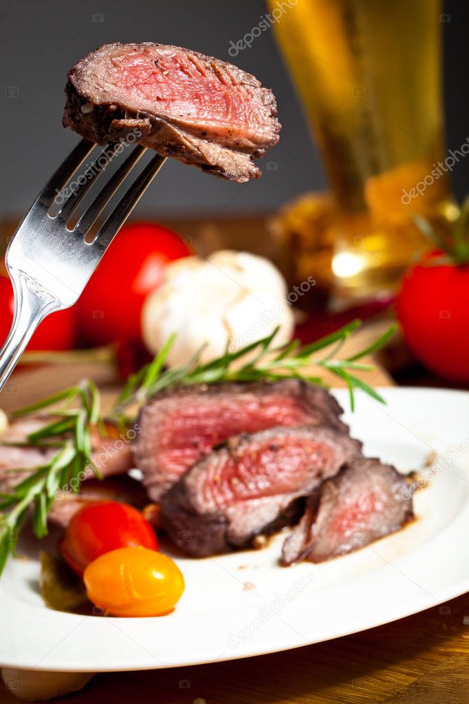 close-up view of fork with delicious grilled venison fillet