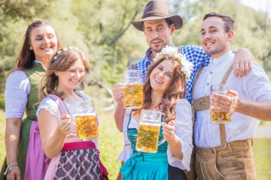 Bavyera kostümleri bira gözlük tutan mutlu genç arkadaşlar açık, oktoberfest kavramı