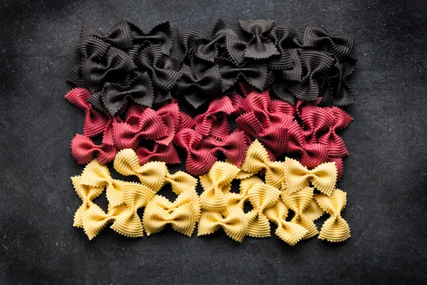 Top View Uncooked Pasta Colors German Flag Black Background — Stock Photo, Image
