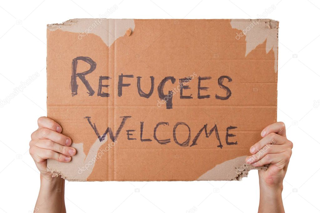 cropped shot of man holding cardboard poster refugees welcome 