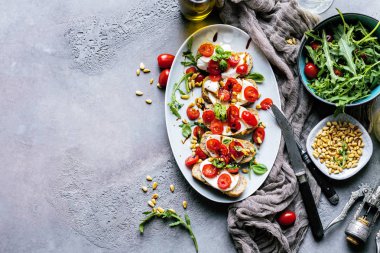 Doğranmış domates, fesleğen ve mozzarella ızgara kabuklu ekmek, üst görünümü ile İtalyan bruschetta