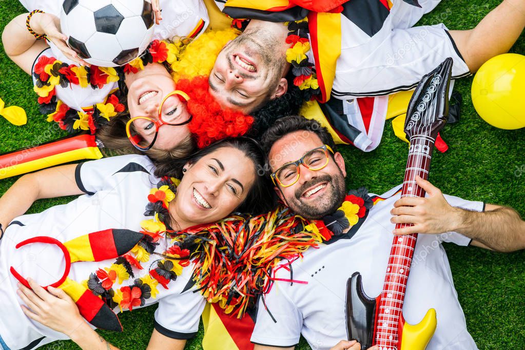 Group of enthusiastic German sport soccer fans celebrating victory.