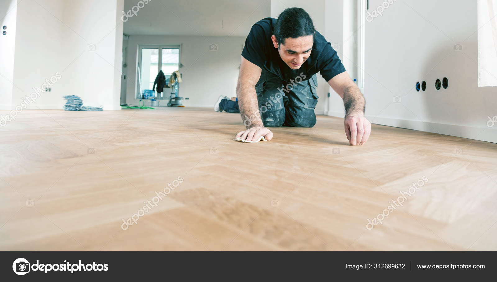 Worker Varnishing Oak Parquet Floor Home Improvement Stock Photo