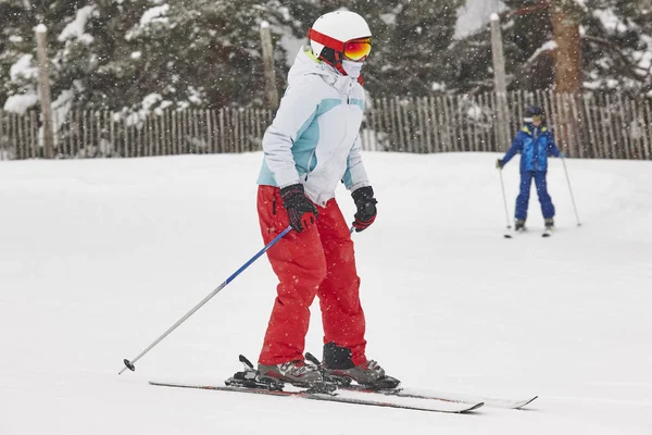 Woman skiing under the snow. Winter sport. Ski slope. Horizontal