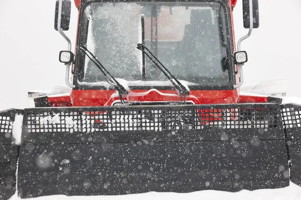 Snow blower truck covered by snow. Winter time. Snowing. Horizontal