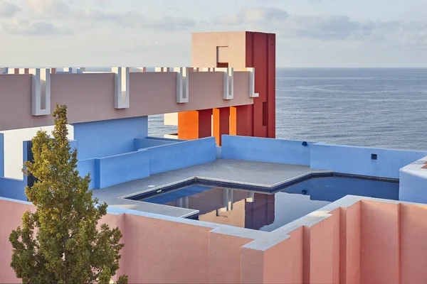 Geometric building construction. The red wall, La manzanera. Calpe, Spain