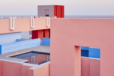 Geometric building swimming pool. Red wall, La manzanera. Calpe, Spain clipart