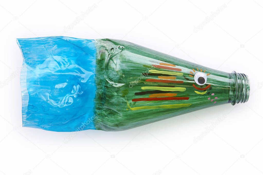 Plastic bottle recycled in a fish figure. Reuse garbage. Isolated