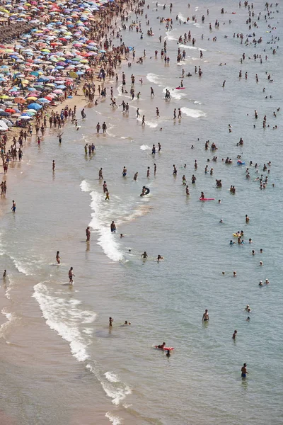 Mediterranean coastline in Spain. Calpe beach. Summer crowd. Alicante seascape