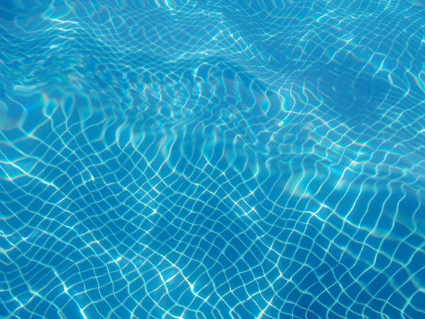 Water reflections on a swimming pool. Underwater photography. Summertime. Horizontal