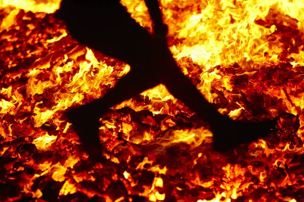 Summer solstice celebration jumping into the fire. Burning flame — Stock Photo, Image