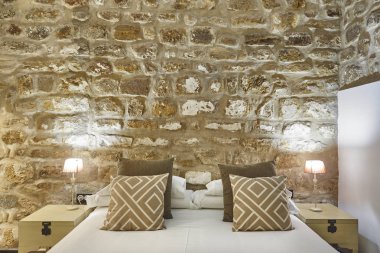 Taş duvarlar ile yatak odası. Konforlu modern otel odası. Interio
