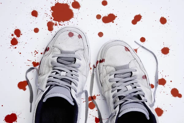 Violence against children. Used bloodstained sneakers — Stock Photo, Image