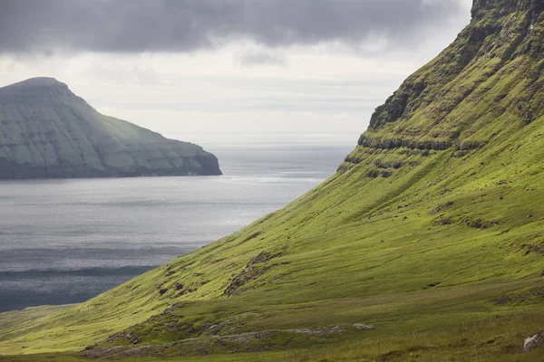 Pitoresk yeşil çim tepeler ve Atlantik Okyanusu. Faroe Adaları. 