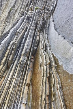 Flysch dramatic rock formation Cantabric coastline in Zumaia, Eu clipart