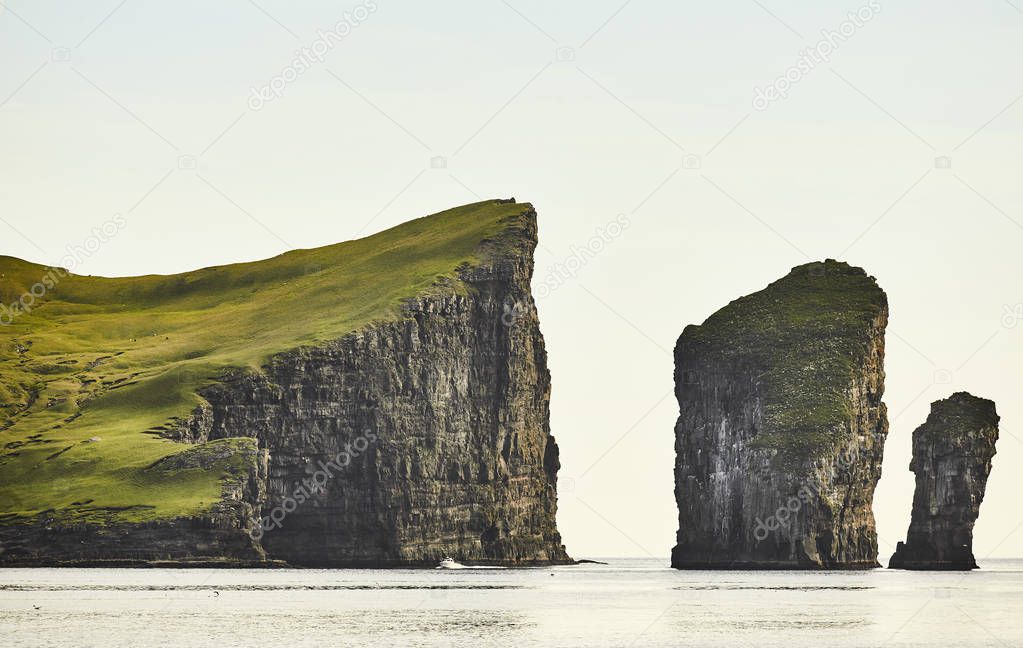 Faroe islands cliffs on atlantic ocean at sunset. Scenic view