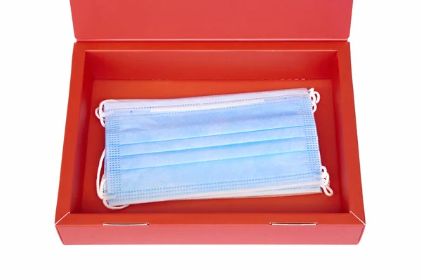 Medical face masks on a red box isolated on white. Gift