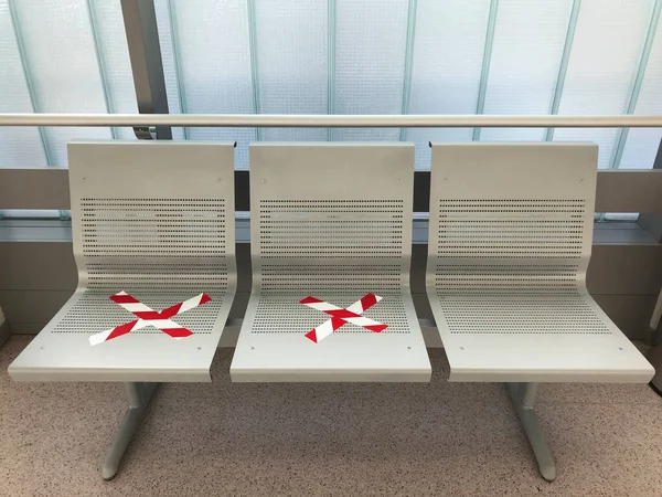 Social distancing. Covid-19 virus protection. Hospital waiting area bench. Hygiene