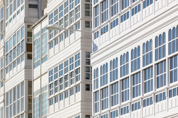 Traditional white balconies glass facades in A Coruna. Galicia, Spain