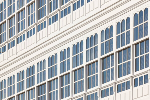 Traditional white balconies glass facades in A Coruna. Galicia, Spain