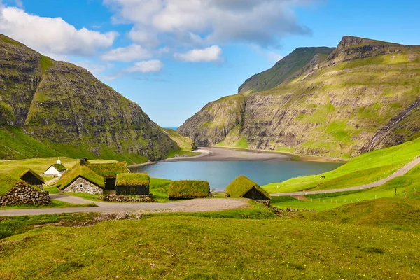 Picturesque green landscape with wooden houses in Faroe islands. Saksun