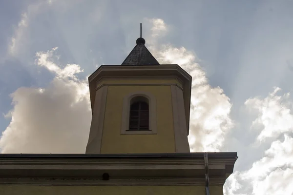 Old Christian temple, church in the local village with dark clouds, bottom view.