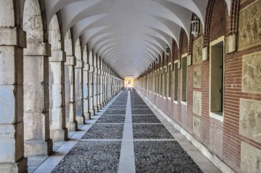 Sütunlar ve kemerler bir tünel şekillendirme ile koridor. Aranjuez bebeklerde evi. Saray binası, düzenlenmiş fotoğrafı çevresinde yol.