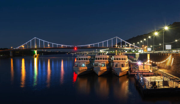 View of Parkovy bridge over Dnieper in Kyiv, Ukraine, in the night