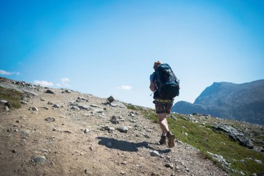 tourist hiking on Besseggen ridge in Jotunheimen National Park, Norway clipart