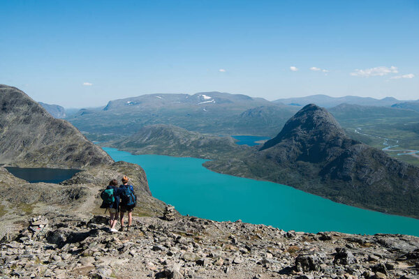 couple hiking on Besseggen ridge in Jotunheimen National Park, Norway 