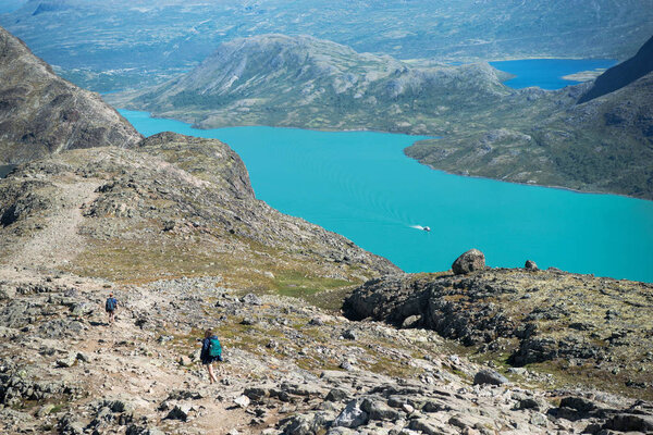 hikers walking on Besseggen ridge in Jotunheimen National Park, Norway 