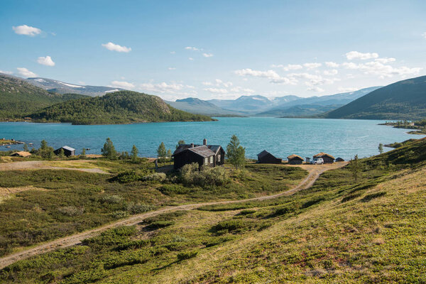wooden buildings in cozy village at Gjende lake, Besseggen ridge, Jotunheimen National Park, Norway