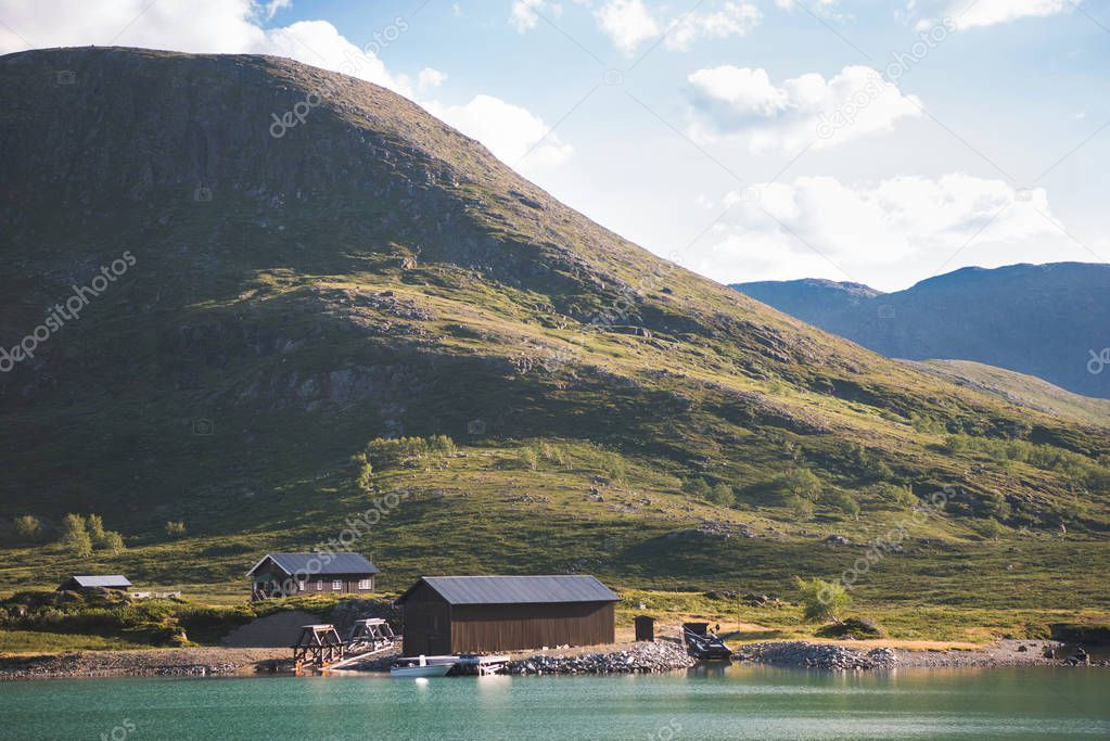 houses and moored boat at Gjende lake, Besseggen ridge, Jotunheimen National Park, Norway