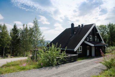 TRYSIL, NORWAY - 26 JULY 2018: black living house at largest ski resort Trysil in Norway  clipart