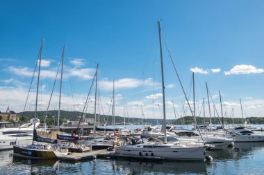OSLO, NORWAY - 28 JULY, 2018: boats and yachts in harbour at Aker Brygge district, Oslo  clipart