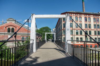 empty bridge across river and beautiful old buildings at sunny day, oslo, norway clipart