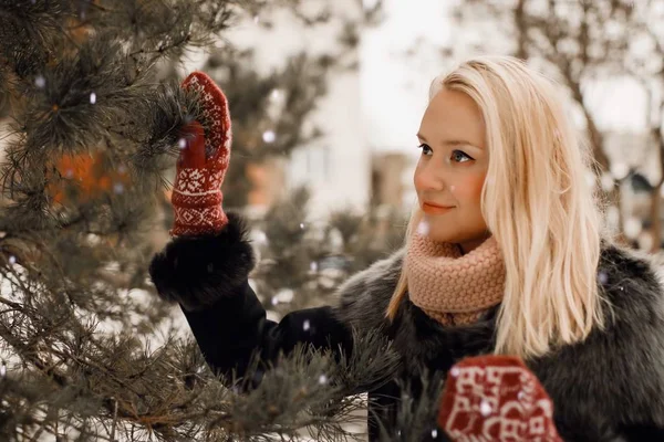 Happy, young europian model with beautiful smile walk in the winter snowy forest