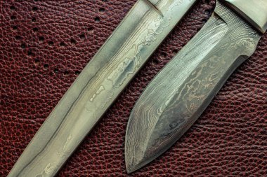 Damascus steel blade of knife. closeup of wootz, blacksmith forging process. clipart