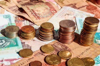 Büyüme grafiği şeklinde sikke yığınları. İş konsepti. Banknot arka planı.