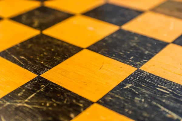 Yellow and black chess squares, located at an angle. Chess game background.