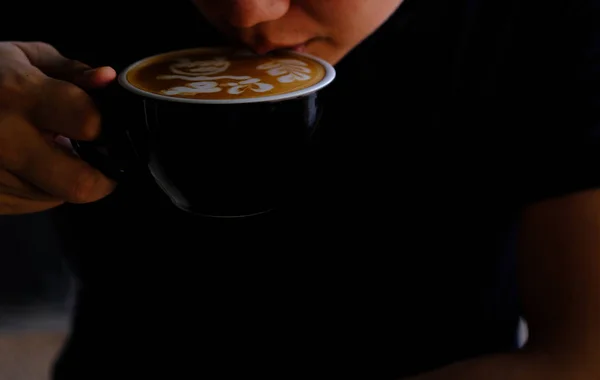 Hand Hold a Cup of Coffee. Menu Drink for Relax on Wood Table Texture and Space for your text. Lifestyle Concept Cafe Design Background.