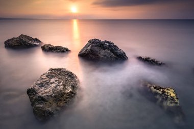 Sunrise nın Almeria İspanya plajlarından. Deniz su ipek etkisi ile yaprakları uzun pozlama.