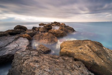 Uzun pozlama üzerinde plaj, El Palmera, Almera, İspanya bulunan bir kaya dalgakıran vurulmuş